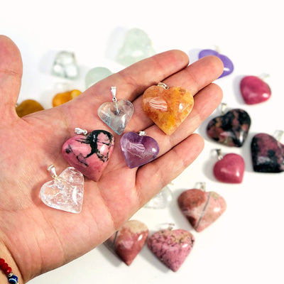 Gemstone Heart Pendants in hand for  size reference