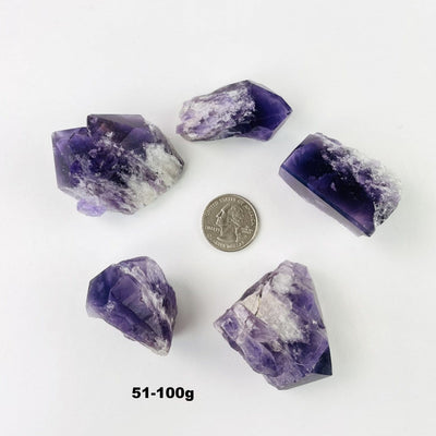 Showing the 51 to 100g of a Elestial Amethyst Point/Cluster with a quarter in the middle 