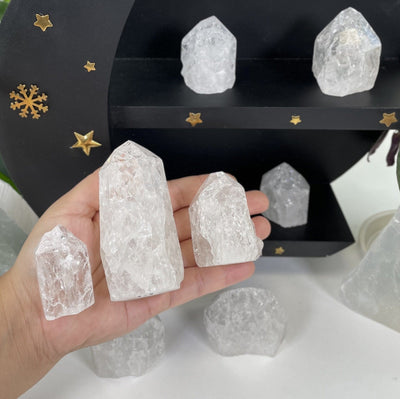Crackle Quartz Semi-Polished Points with varying sizes in a hand for reference