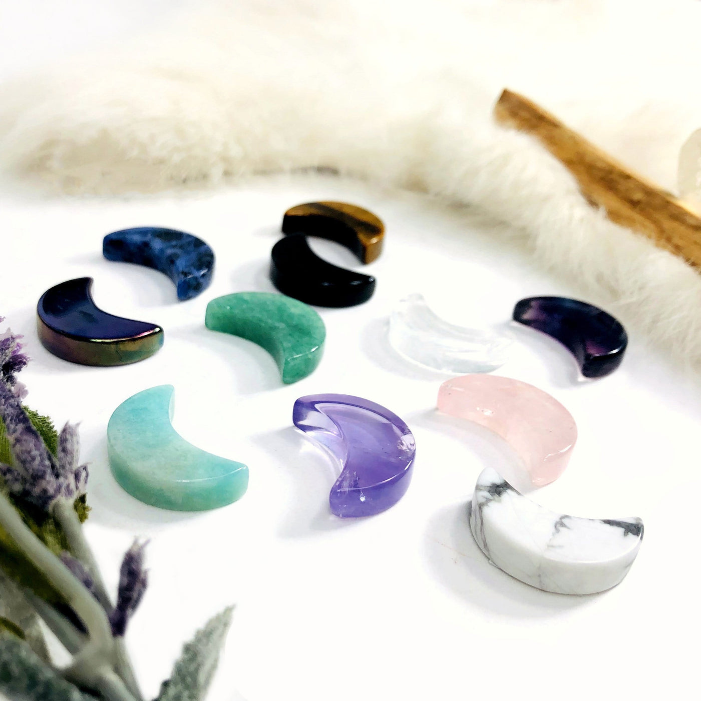 Gemstone Moon Cabochons of assorted stones from a side angle to see thickness