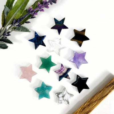 11 different Star Gemstone Cabochons displayed on a white surface
