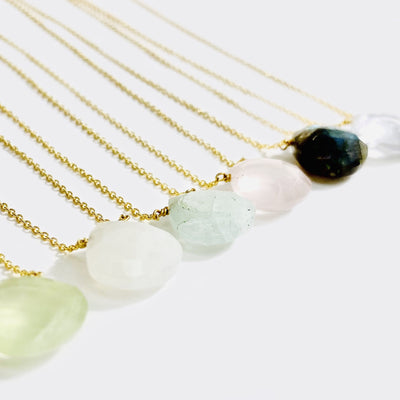side view of 6 gemstone drop necklace in gold
