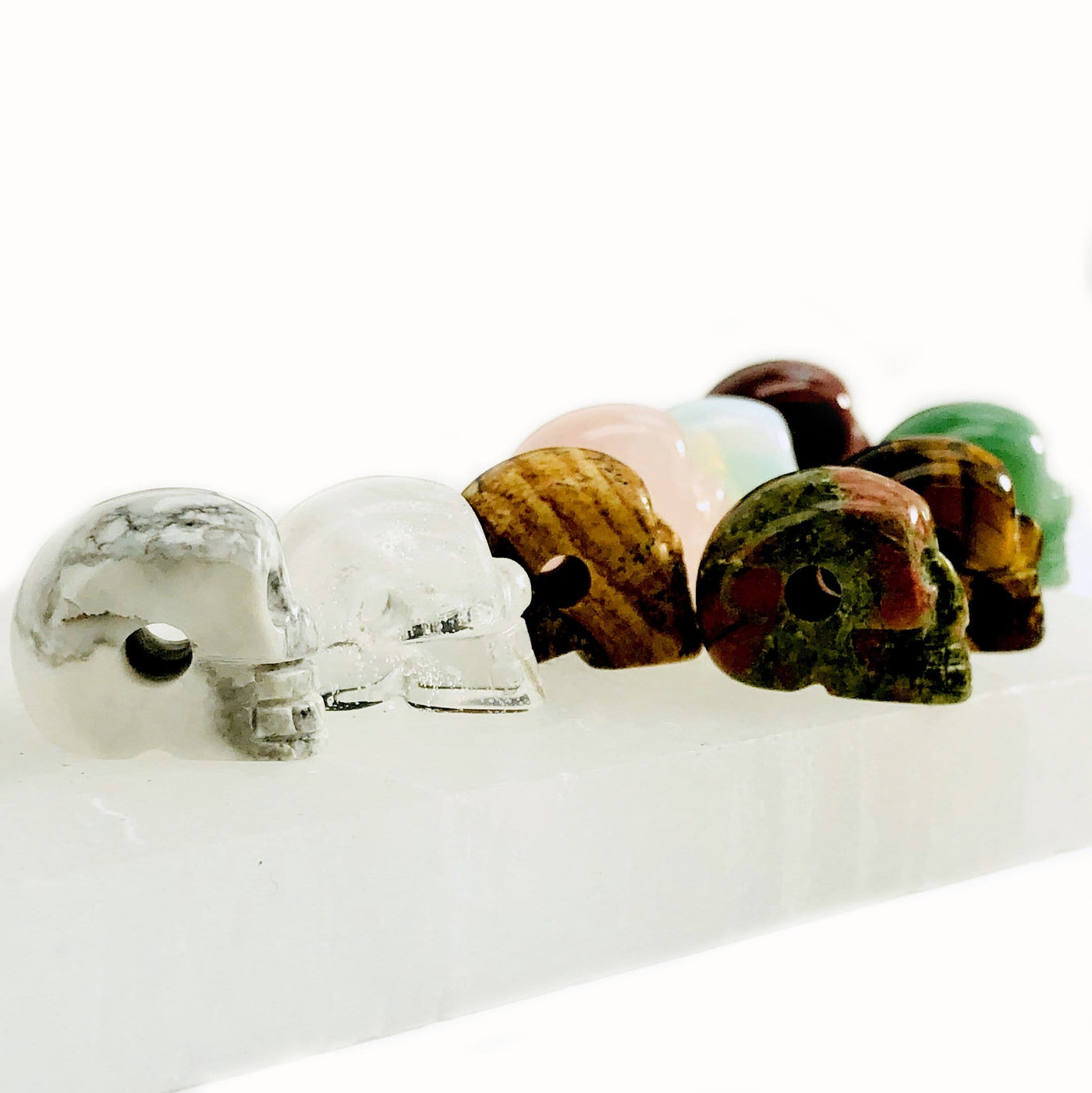 side view of many gemstone skull beads for drill details