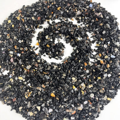 Black Onyx 1lb bag - Tiny Chips spread out on a table