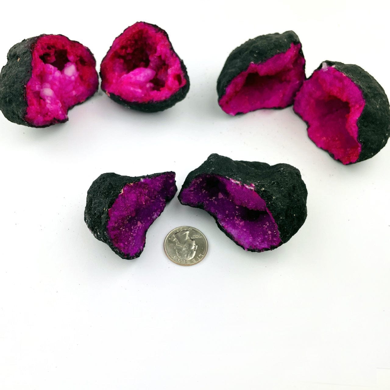 Hot Pink Color Dyed opened Geodes next to a quarter for size reference