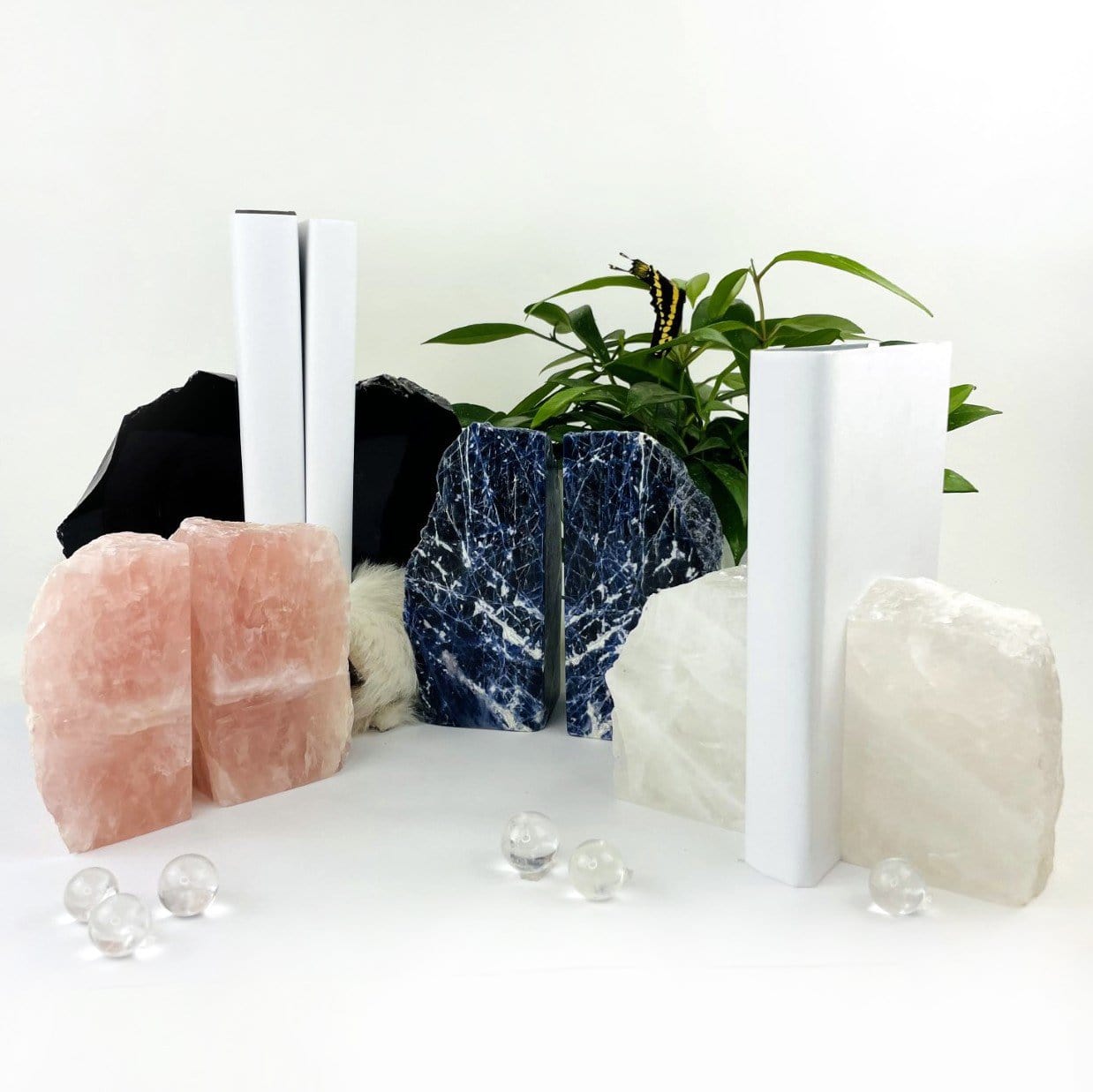 A photo showing all of our stone bookends on a white background.  PIctured are Rose Quartz, Crystal Quartz, Sodalite and Black Obsidian bookends.