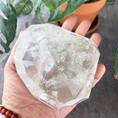 Crystal Quartz Polished Stone in a hand for size reference
