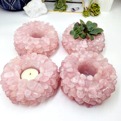 4 Rose Quartz Tumbled Crystal Candle Holders one with a candle and one with a plant