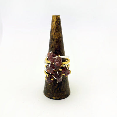 Garnet Gemstone Rings in Gold and Silver stacked on display
