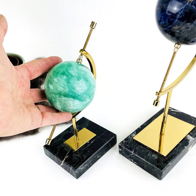 hand next to Sphere Holder with Caliper with another one near it