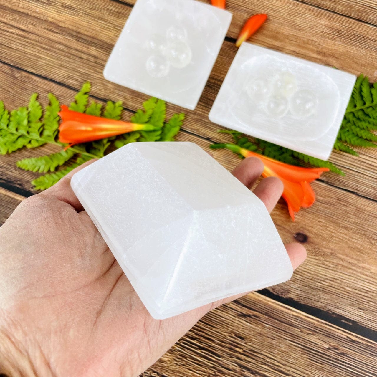 bottom of selenite rectangle dish in hand for size reference and details