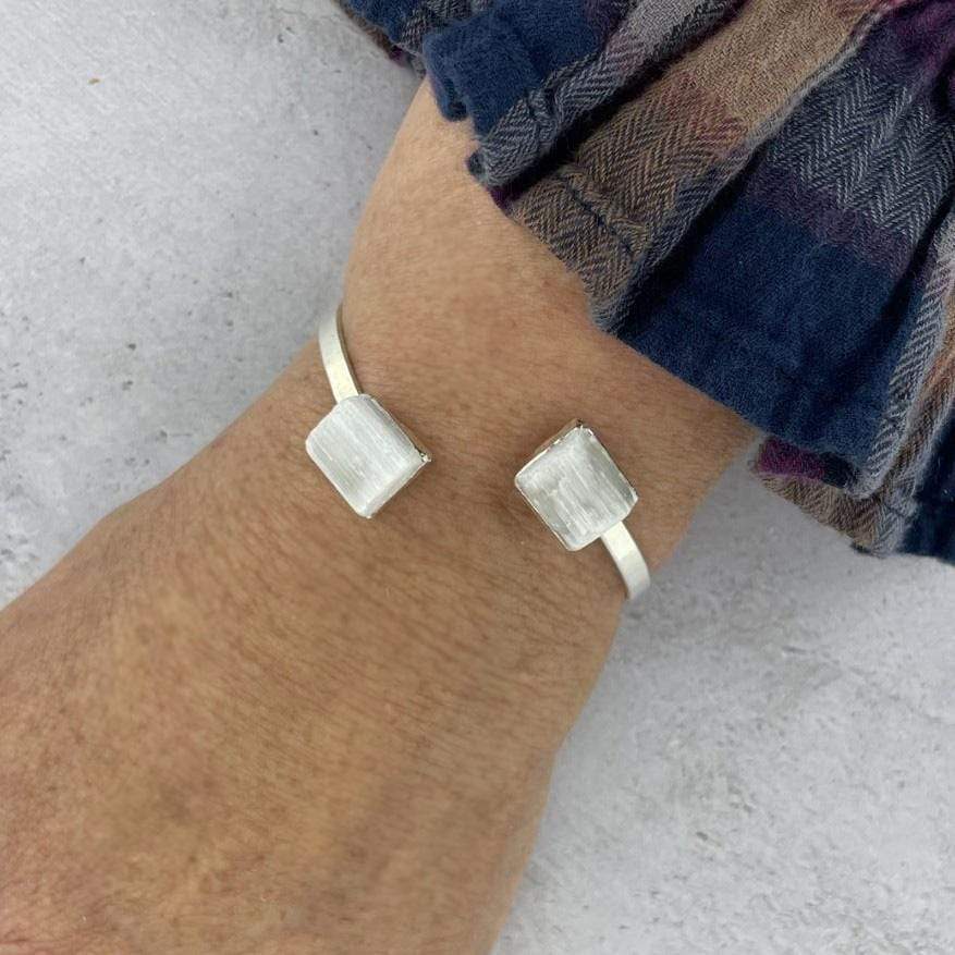 silver selenite cuff bracelet on wrist for size reference