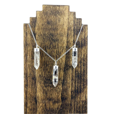 Silver plated chain displayed on necklace wooden stand