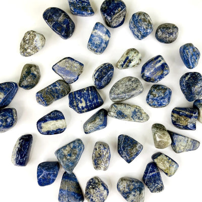 Tumbled Lapis Lazuli stones spread out on a table