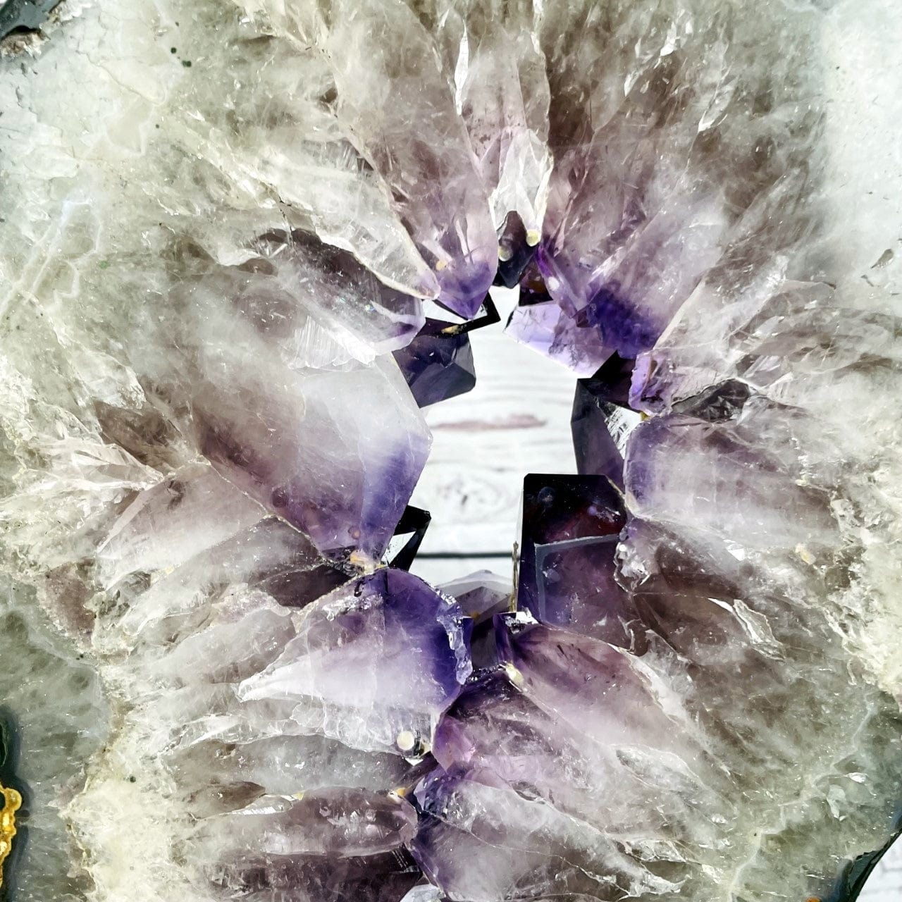 Amethyst Slice in shape of 8 on Metal Stand up close of purple crystals