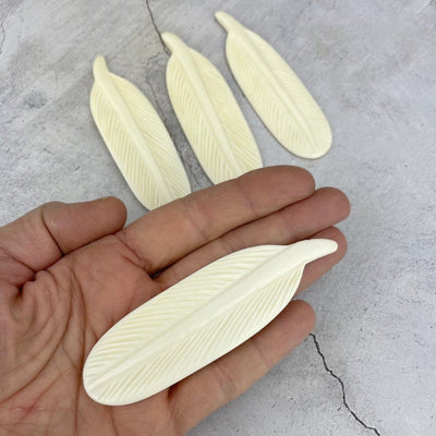 Large Bone Feather Bead  - one in a hand