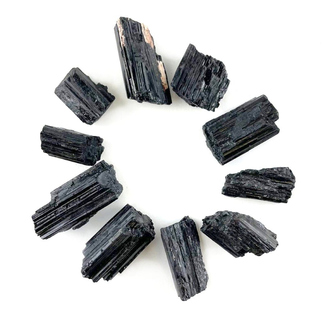 multiple black tourmaline pendant sized rods displaying different sizes and textures 