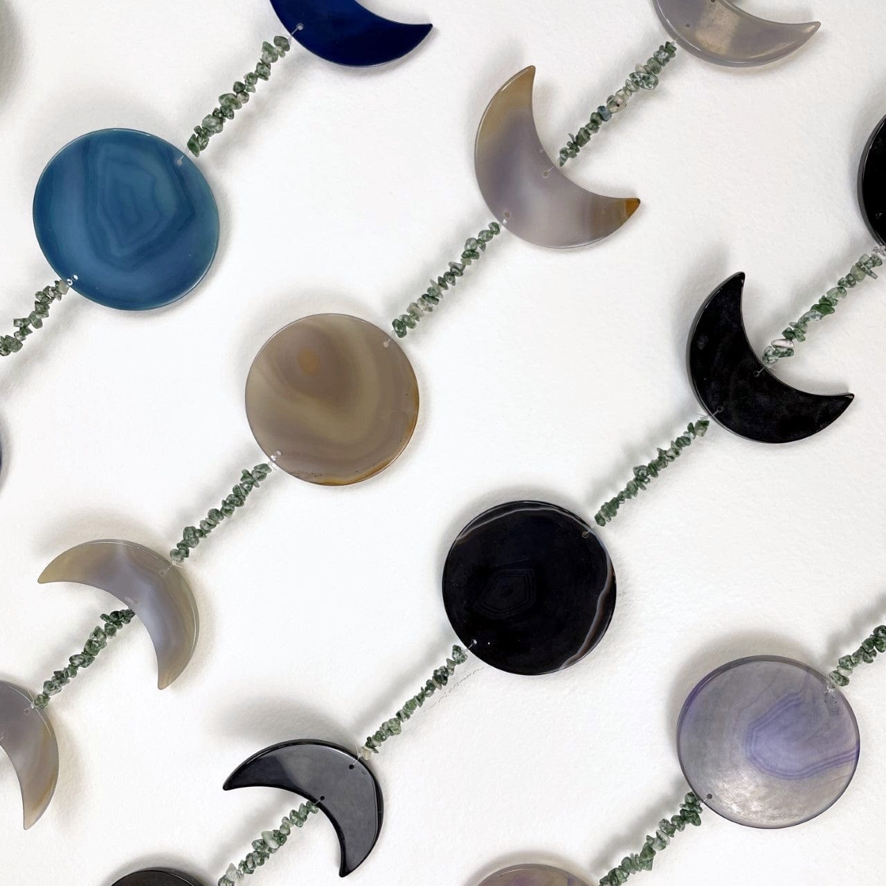 Colored agate moon phase shapes with the moss agate stone beads up close