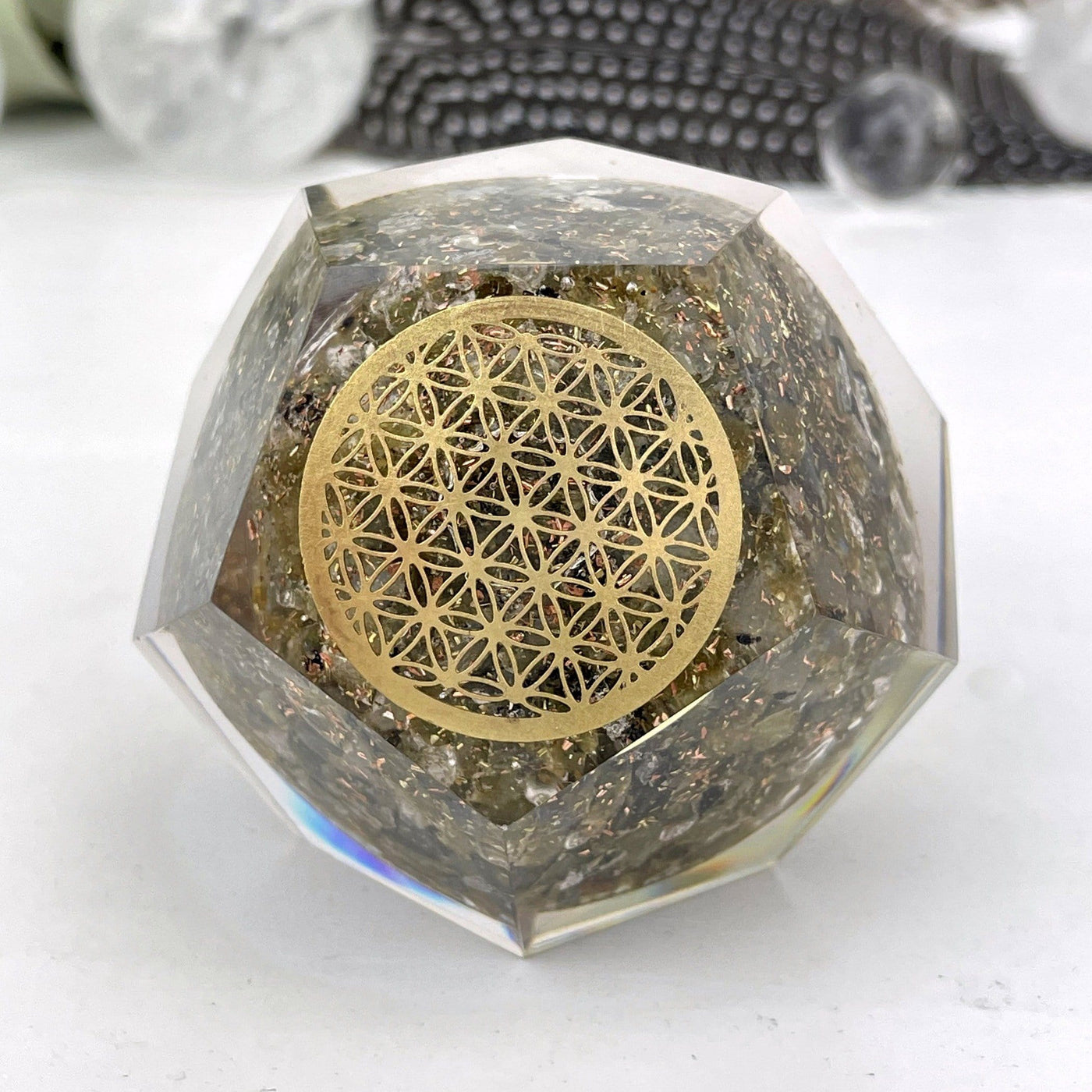 Orgone Energy - Labradorite with Gold Flower of Life Grid - Dodecahedron shaped-- close shot view of dodecahedron on table.