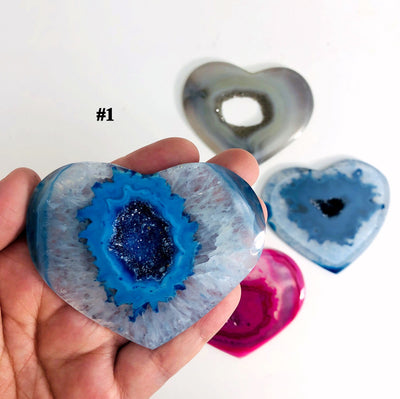 close up of #1 heart shaped druzy agate on hand for size reference
