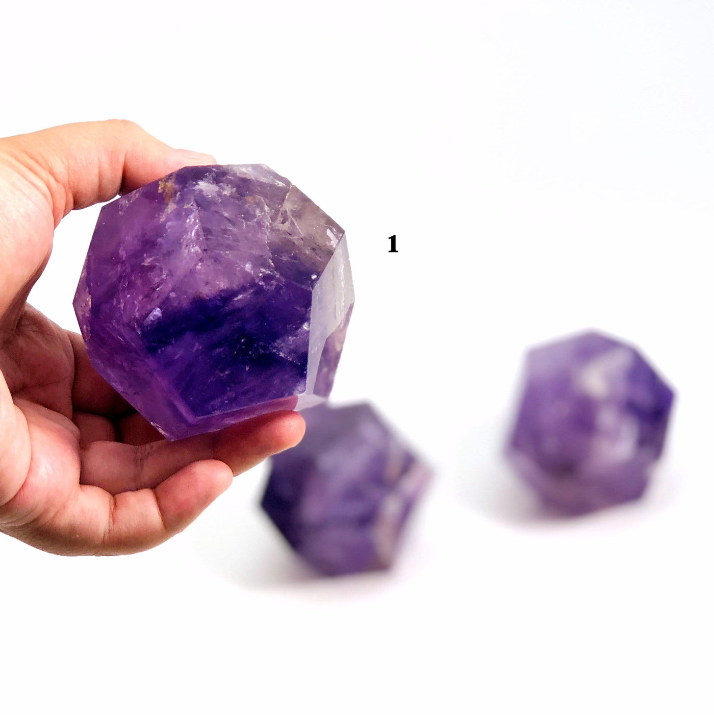 hand holding up Amethyst Dodecahedron