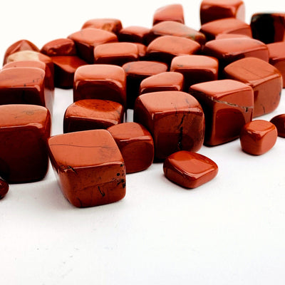 side view of Red Jasper Cubed Tumbled Stones on white background
