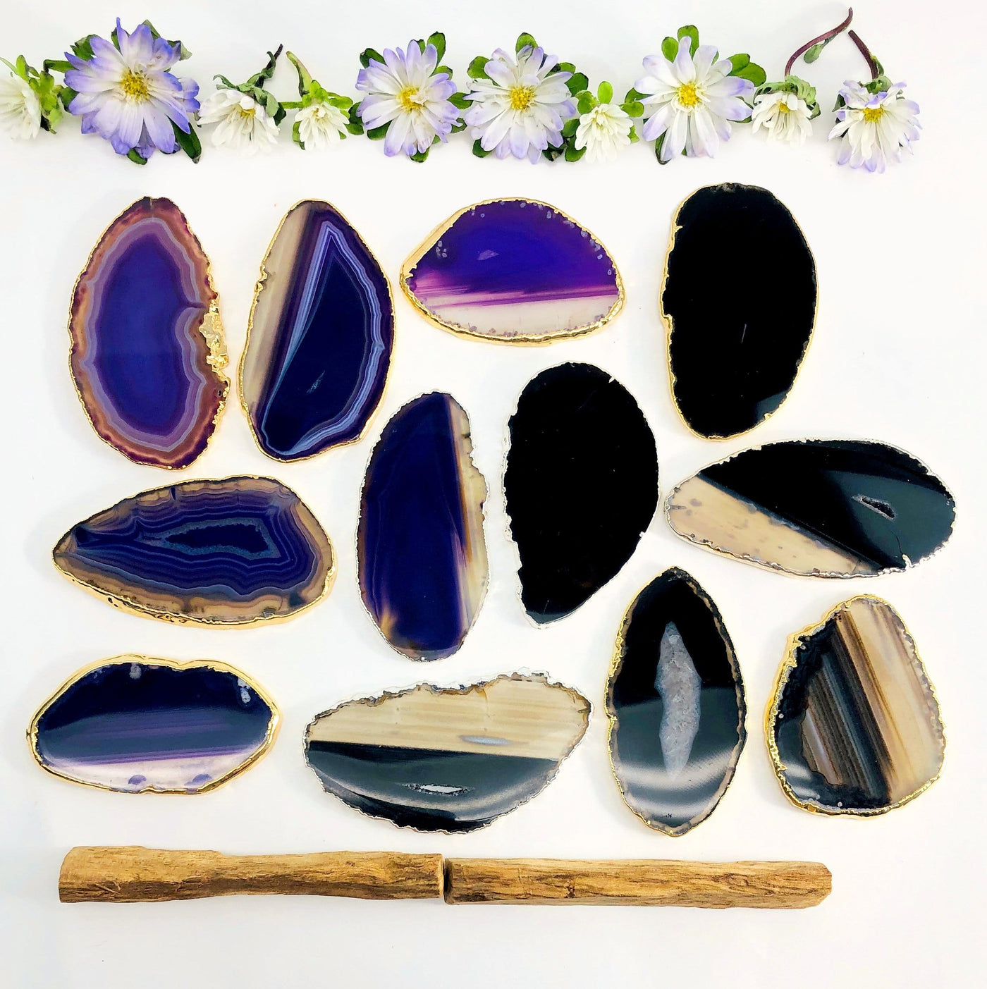 Picture of a purple and black agate slices being displayed on a white back ground. 