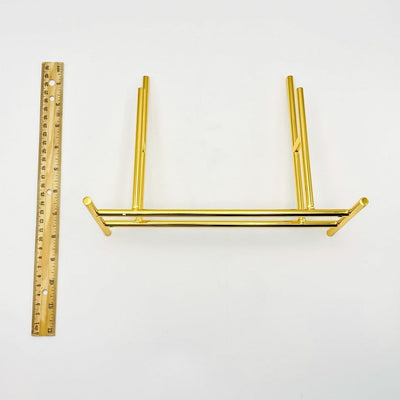 Display Stand Gold Color Next to a Ruler Showing the Size n White Background.