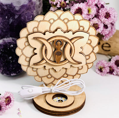 Earth Goddess and Moon Wooden Sphere Stand Lamp Sphere is not included on a flower background 