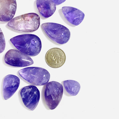amethyst drops next to a quarter for size reference 