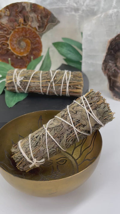 video of mugwort smudge bundle being burnt in a bowl