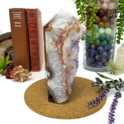 side view of Amethyst Geode Druzy Polished Cut Base with decorations in the background