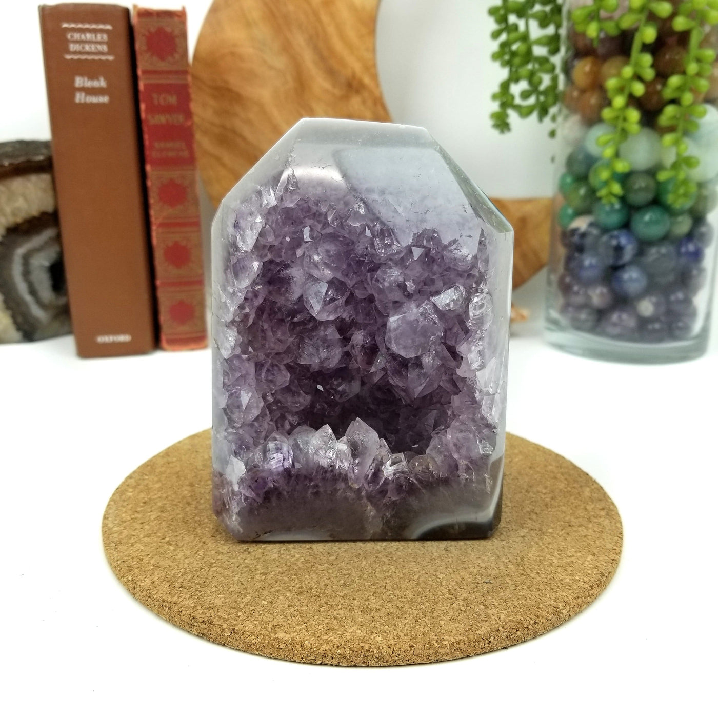 Amethyst Geode Druzy Polished Cut Base with decorations in the background