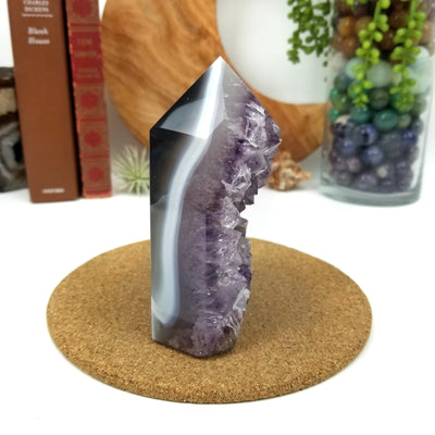side view of Amethyst Geode Druzy Polished Cut Base with decorations in the background