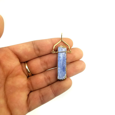 hand holding up Blue Kyanite Slab Gold Plated Bail