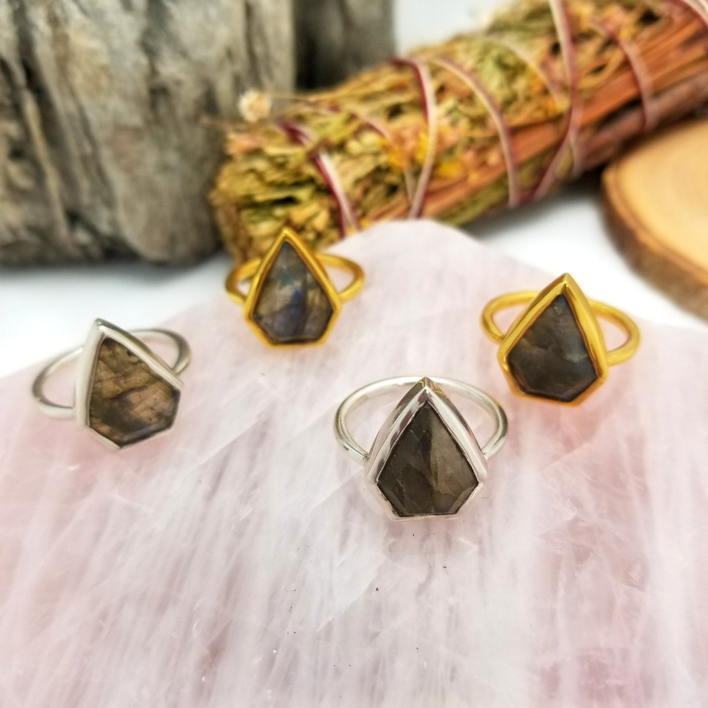 4 labradorite arrowhead rings in gold and silver with decorations is the background