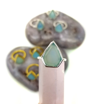 Aqua Chalcedony Arrowhead Stone ring in silver held up with others in the background