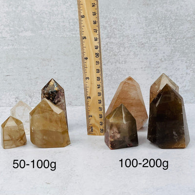 Rutilated Quartz Points next to a ruler for size reference 