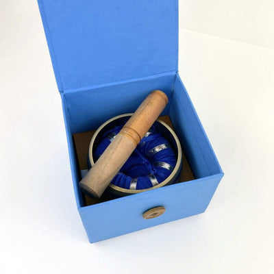 Blue singing bowl in blue open  box, with pillow and mallot