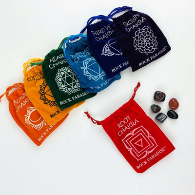 The Root Chakra Set opened up wth the stones next to the bag and all the other sets lined up behind