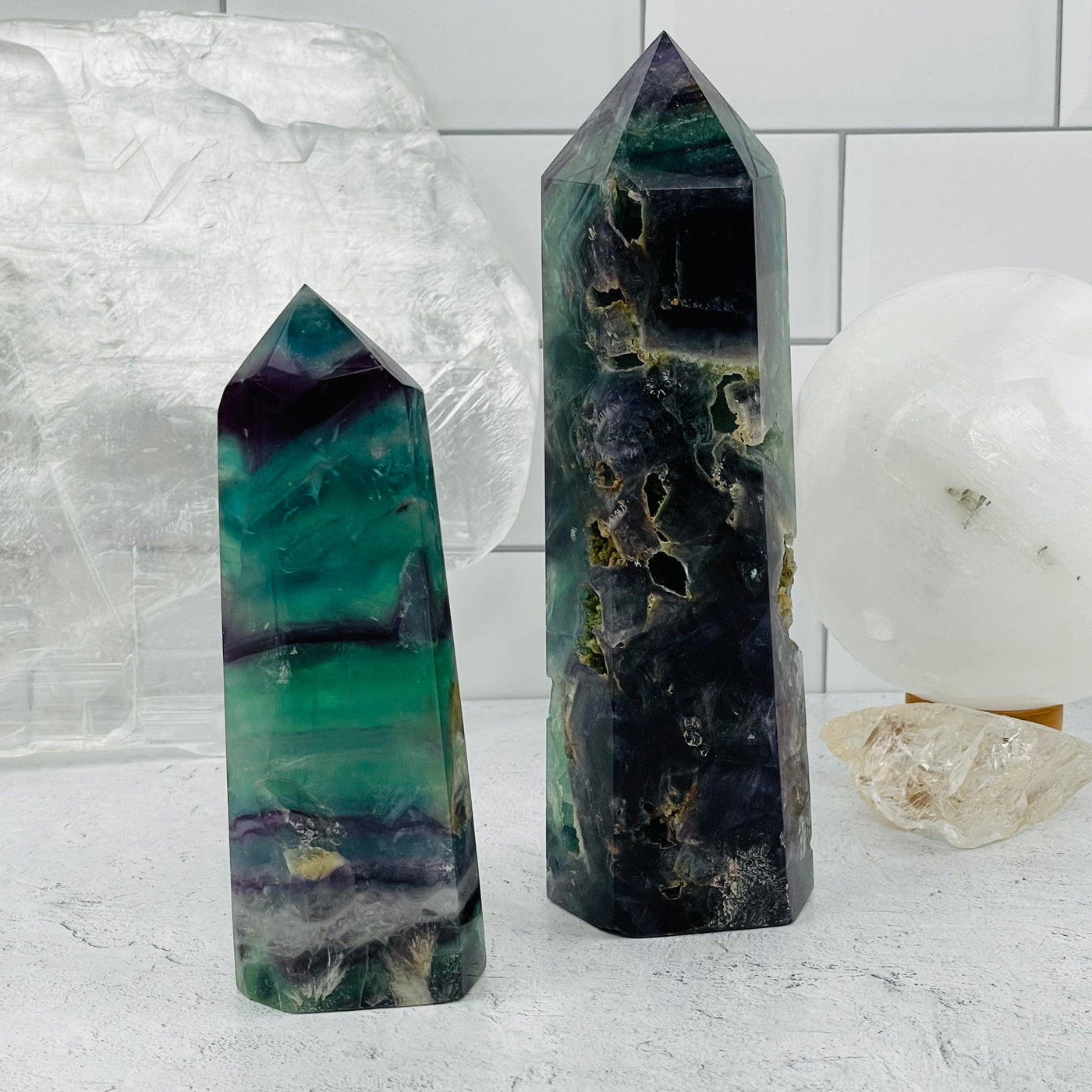 Two Rainbow Fluorite Polished Point Towers displayed as home decor 