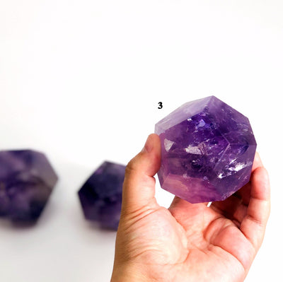 hand holding up Amethyst Dodecahedron