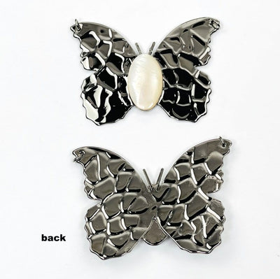 gunmetal butterfly pendants with a mother of pearl center displaying front and back side 