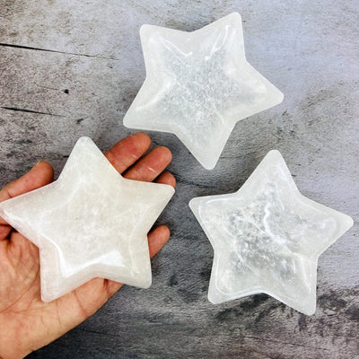Selenite Star Bowl - Charging Station with a hand for size