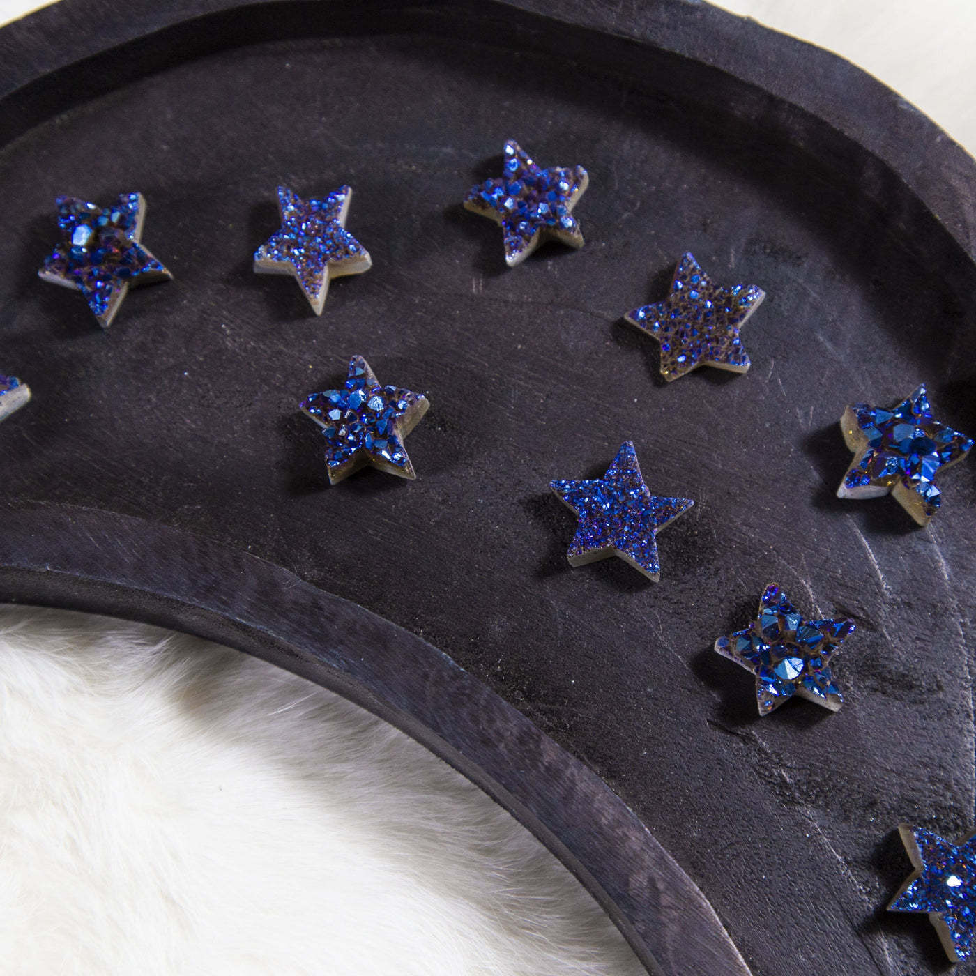 titanium blue druzy stars on wooden plate