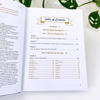 Book Tarot for self-care on a table showing you the table of contents