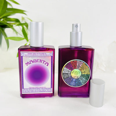 2 bottles of Gemstone Mist - Magenta Vibrational Color with decorations in the background