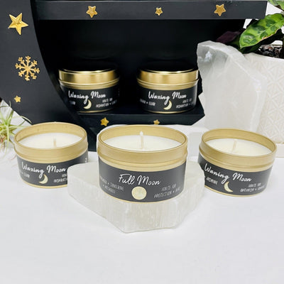 5 Moon Phase Candles with decorations in the background