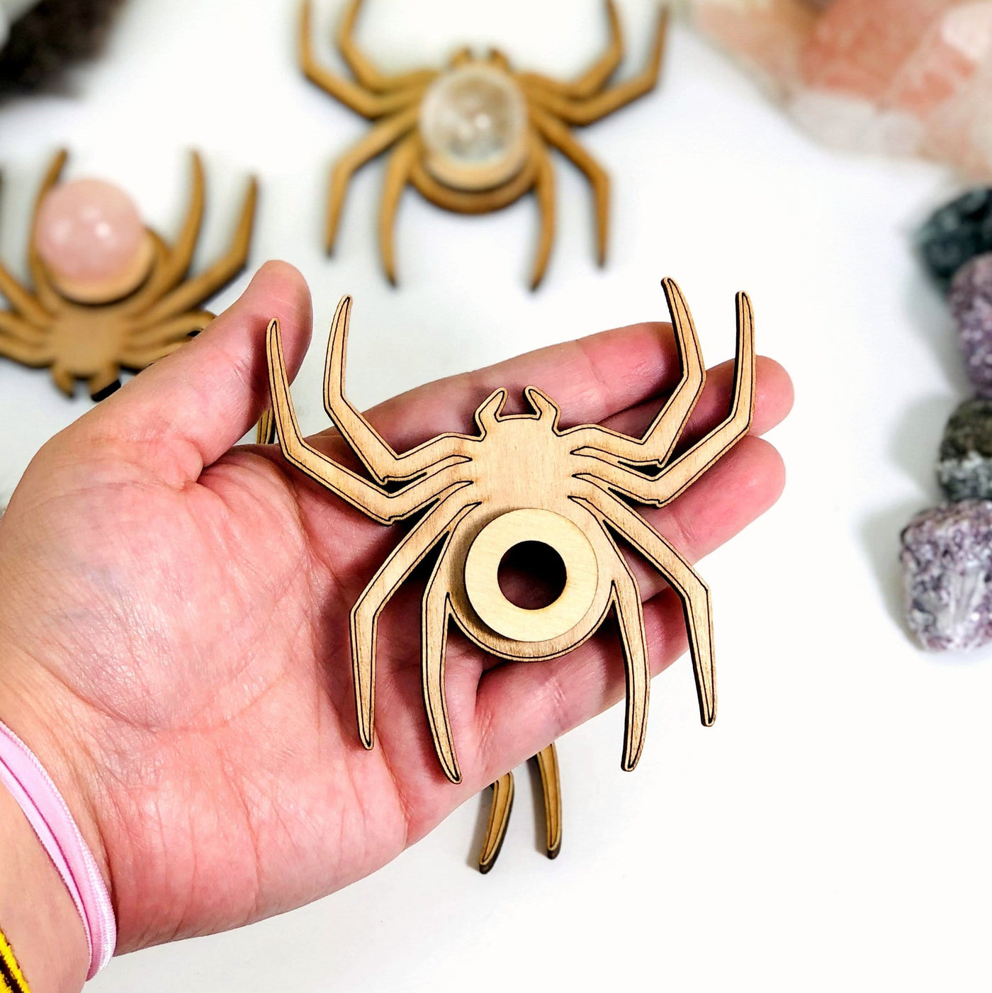 wood spider stand in a hand