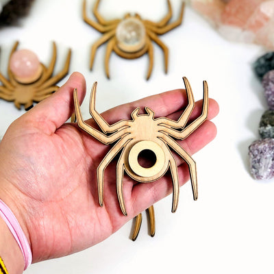 wood spider stand in a hand